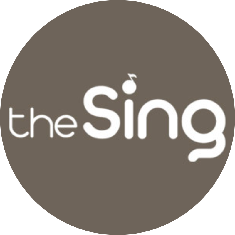 White "theSing" logo with a musical note above the lowercase i on a taupe background