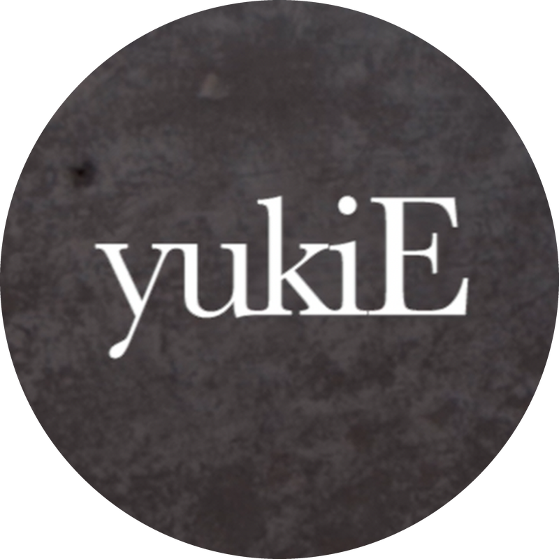 White “yukiE” text on a dark textured background