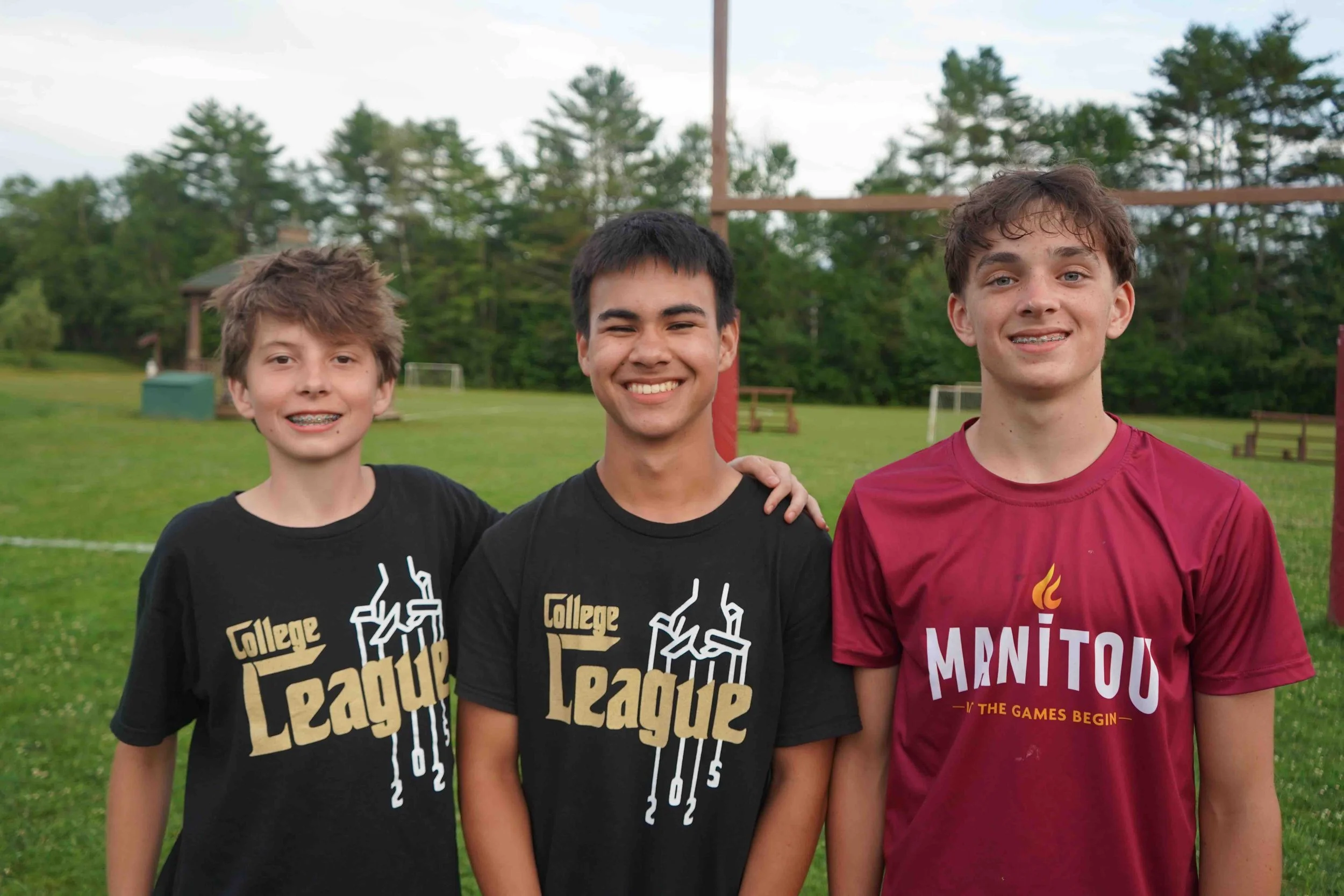 Three teens stand together at camp, highlighting leadership development for kids, social development for children, and building confidence in your child through meaningful summer camp experiences.