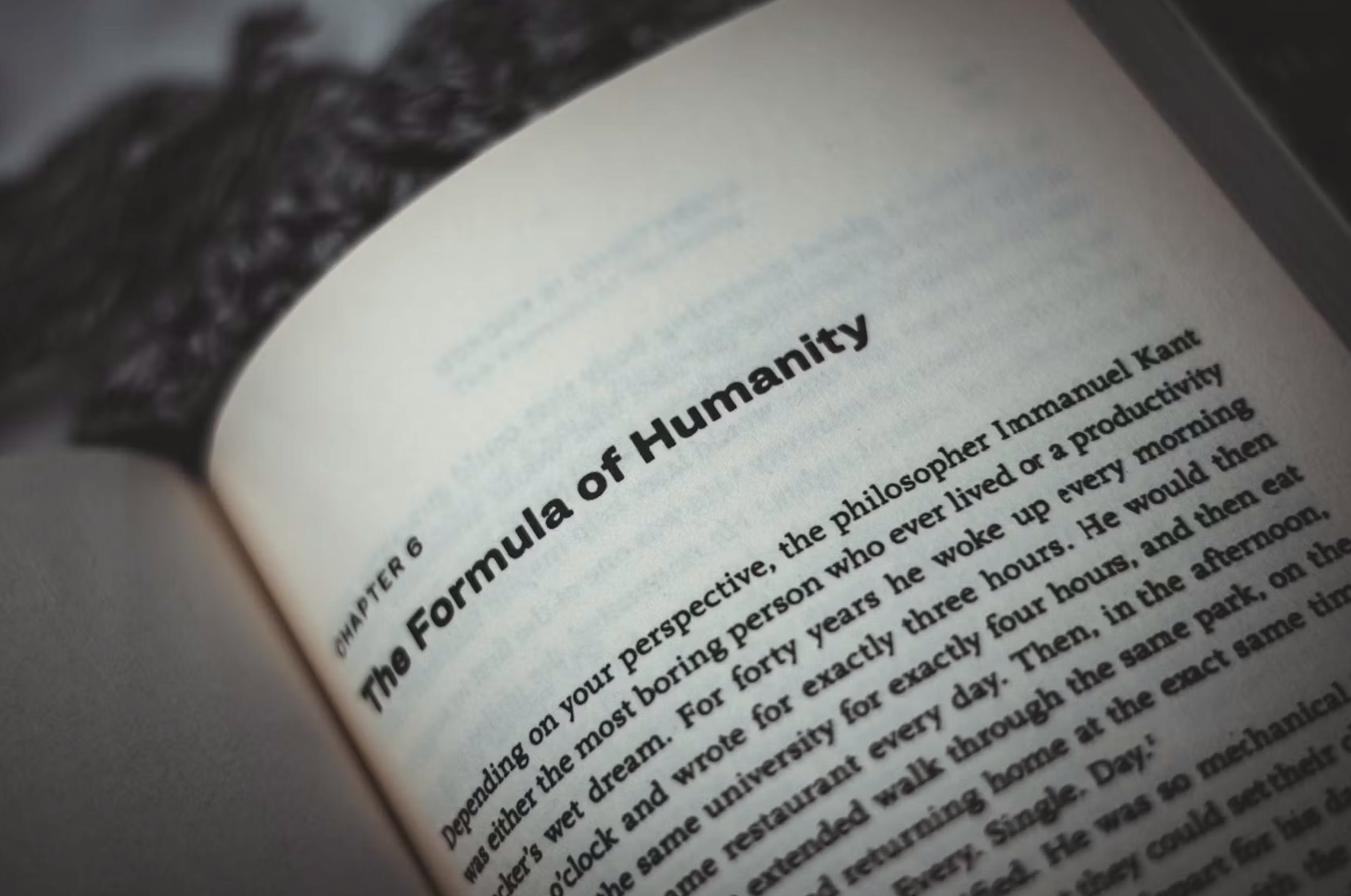 A close-up photograph of an open book page with the chapter heading 'The Formula of Humanity' visible, printed in bold text.
