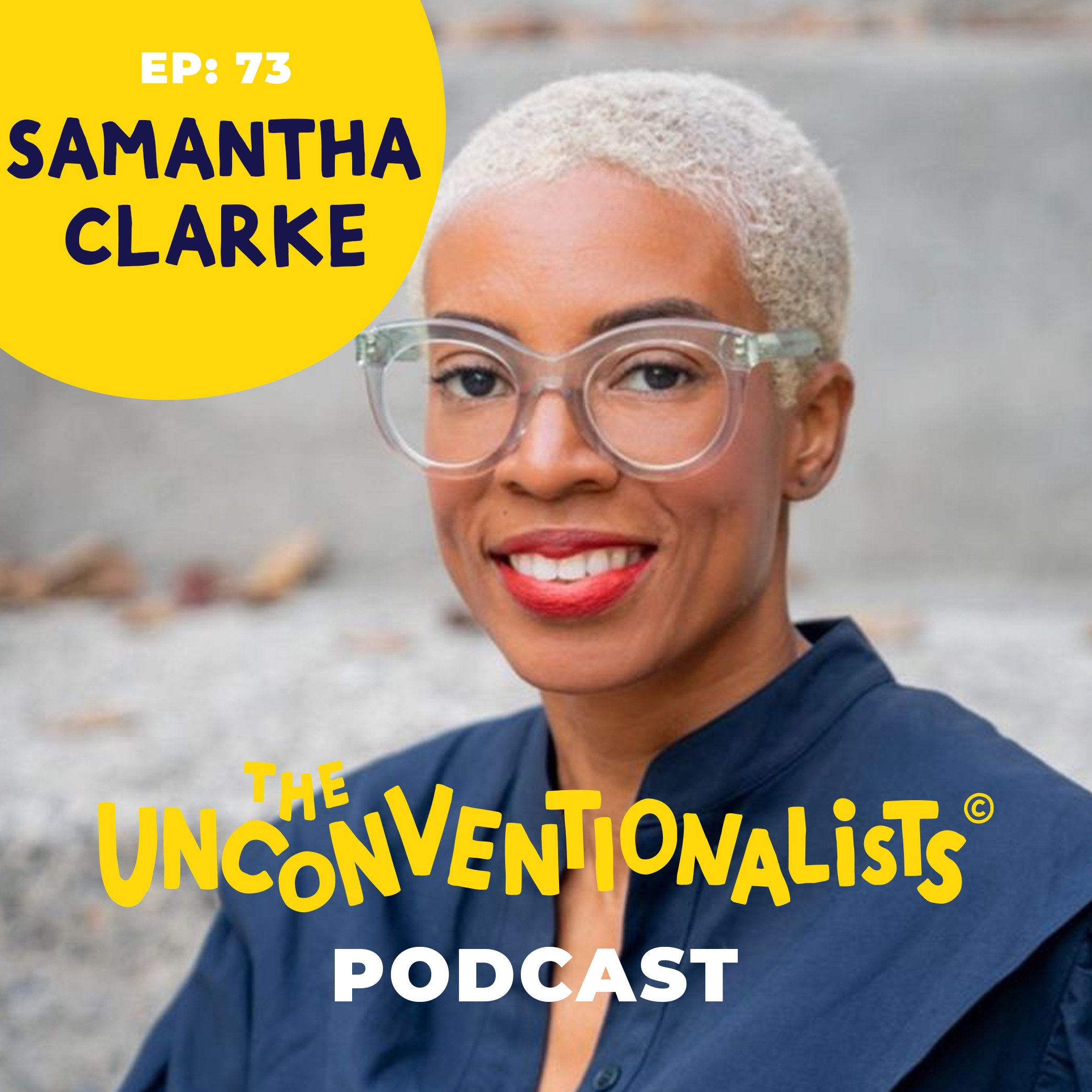 Close-up of a woman with short gray hair and glasses, smiling, holding a yellow sign with black and yellow text that reads 'EP: 73 SAMANTHA CLARKE THE UNCONVENTIONALIST PODCAST' in an outdoor setting.