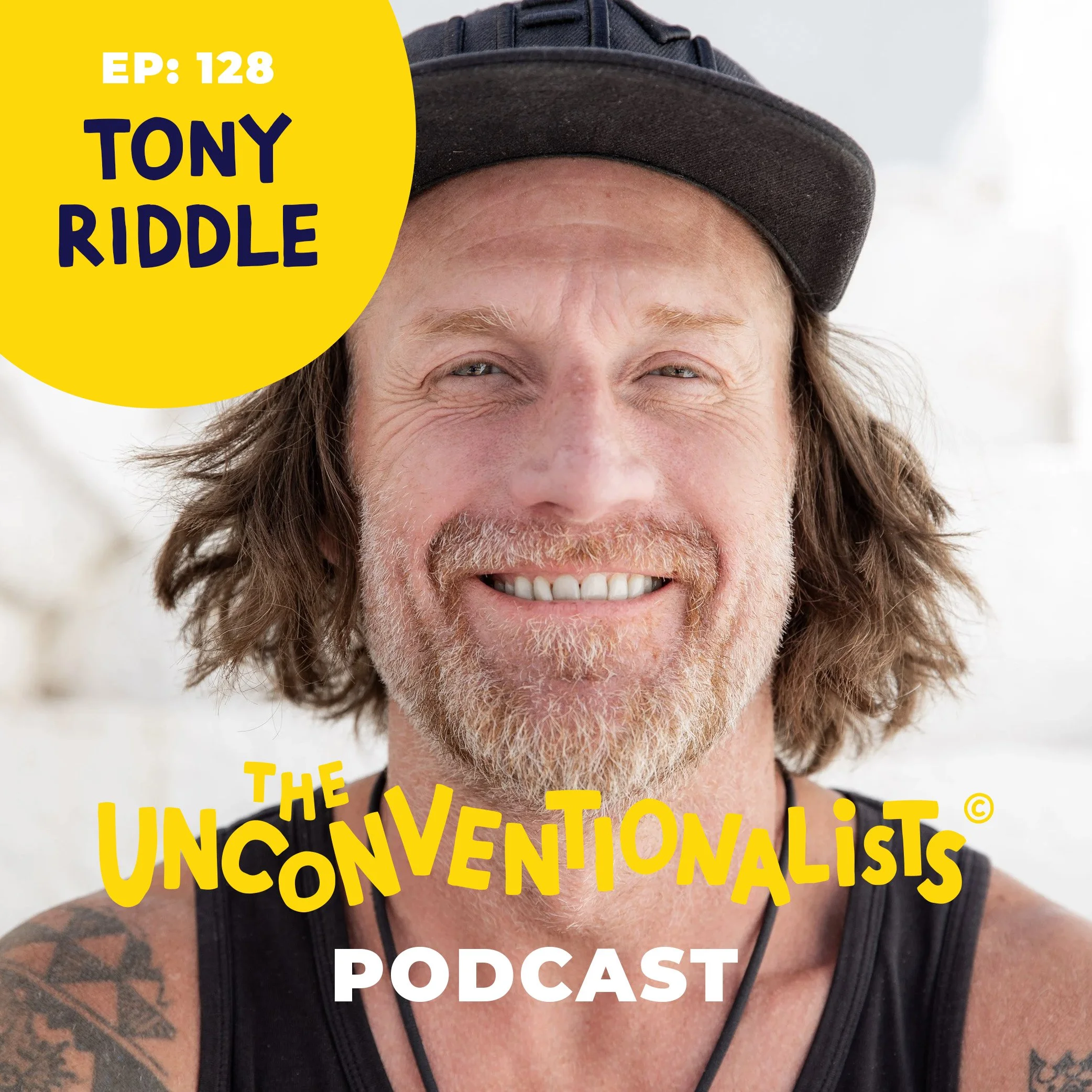 Close-up of a smiling man with long hair, a beard, and tattoos wearing a dark cap and a tank top in front of a light background, with text overlay about a podcast episode and unconvencionalist.