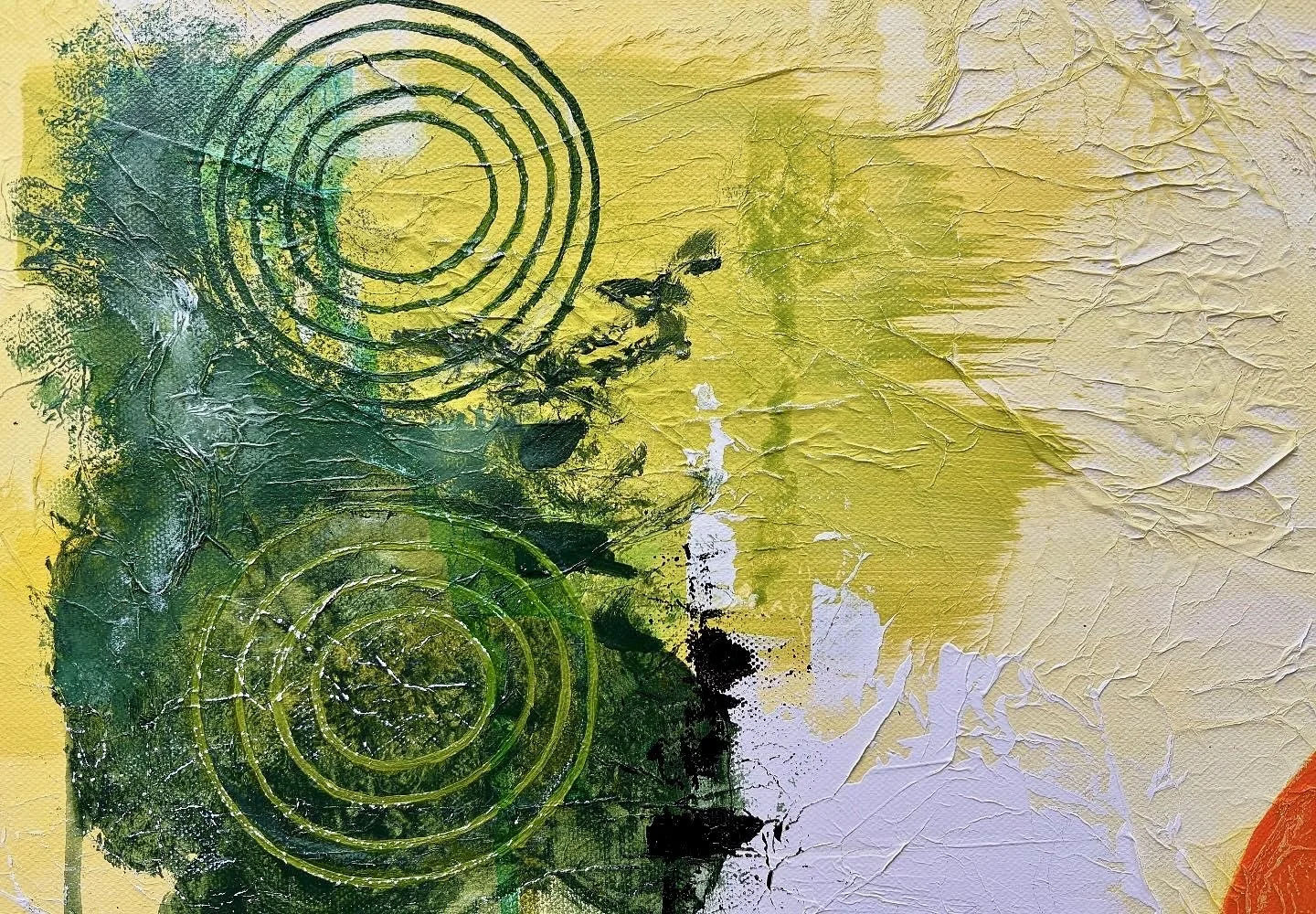 Abstract textured painting with green and yellow colors, featuring circular patterns and splashes of white and black.