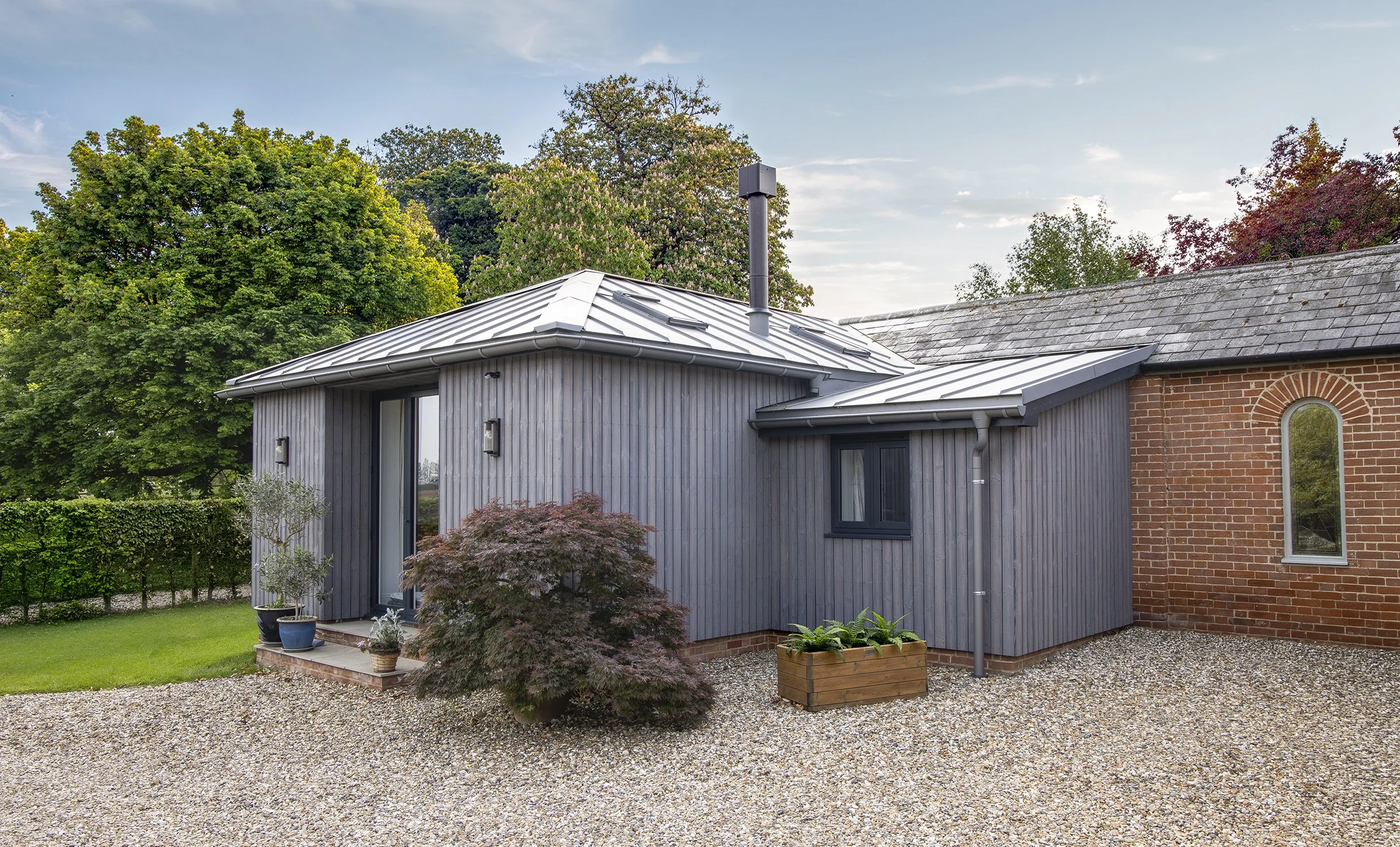 Modern house renovation in Suffolk with grey slatted porch