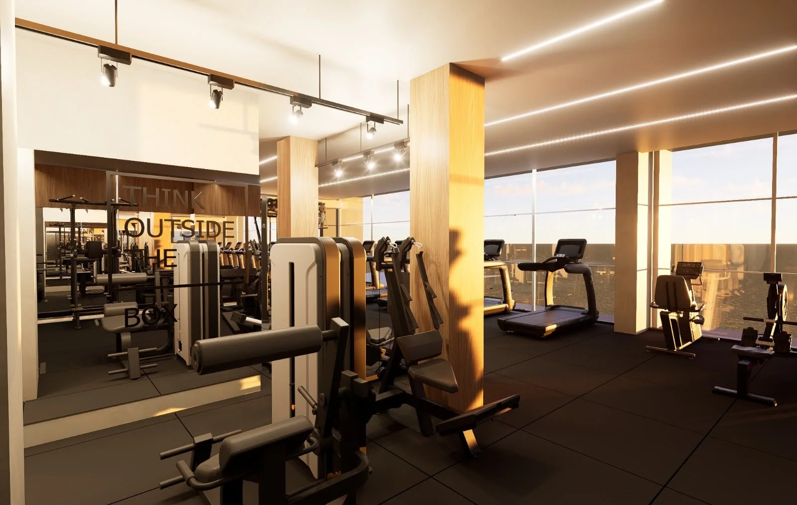 Interior de academia com equipamentos de ginástica ao lado de janelas grandes com vista para o céu ao pôr do sol, iluminação moderna no teto e paredes de madeira.