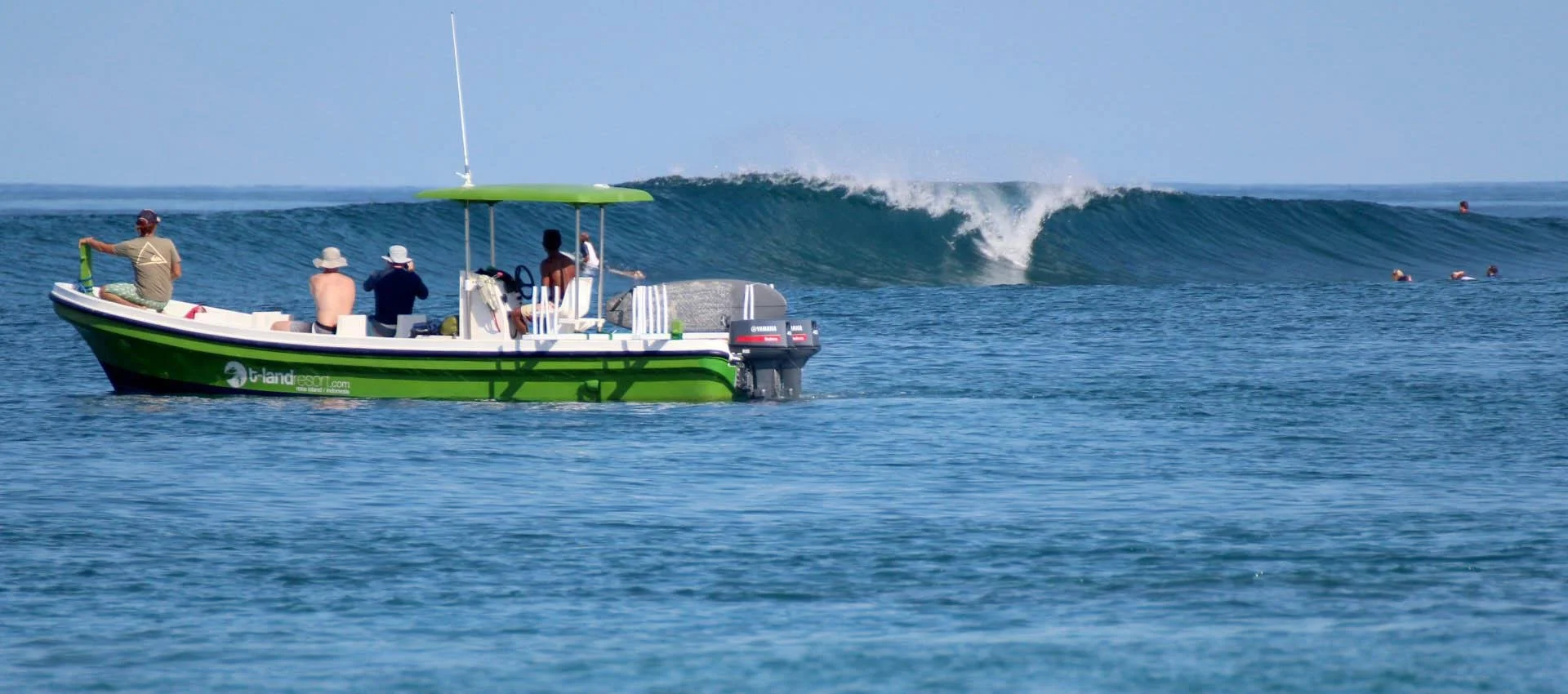 Boa surf break near Nembrala, Rote Island, with surfers and a boat in the lineup
