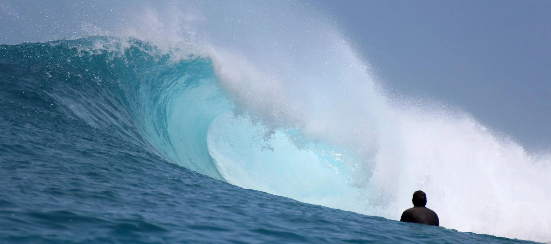 Hollow blue wave breaking at Do'o surf break off Rote Island, Indonesia