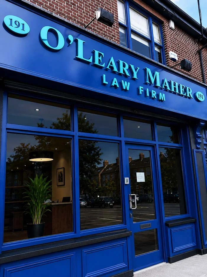 Exterior of a law firm office named 'O'Leary Maher Law Firm' with blue signage and window framing, located at street 191.