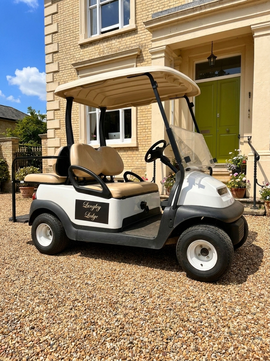 A white and black golf cart parked on a gravel driveway in front of a house with a lime green door and windows, with potted plants and flowerpots nearby.