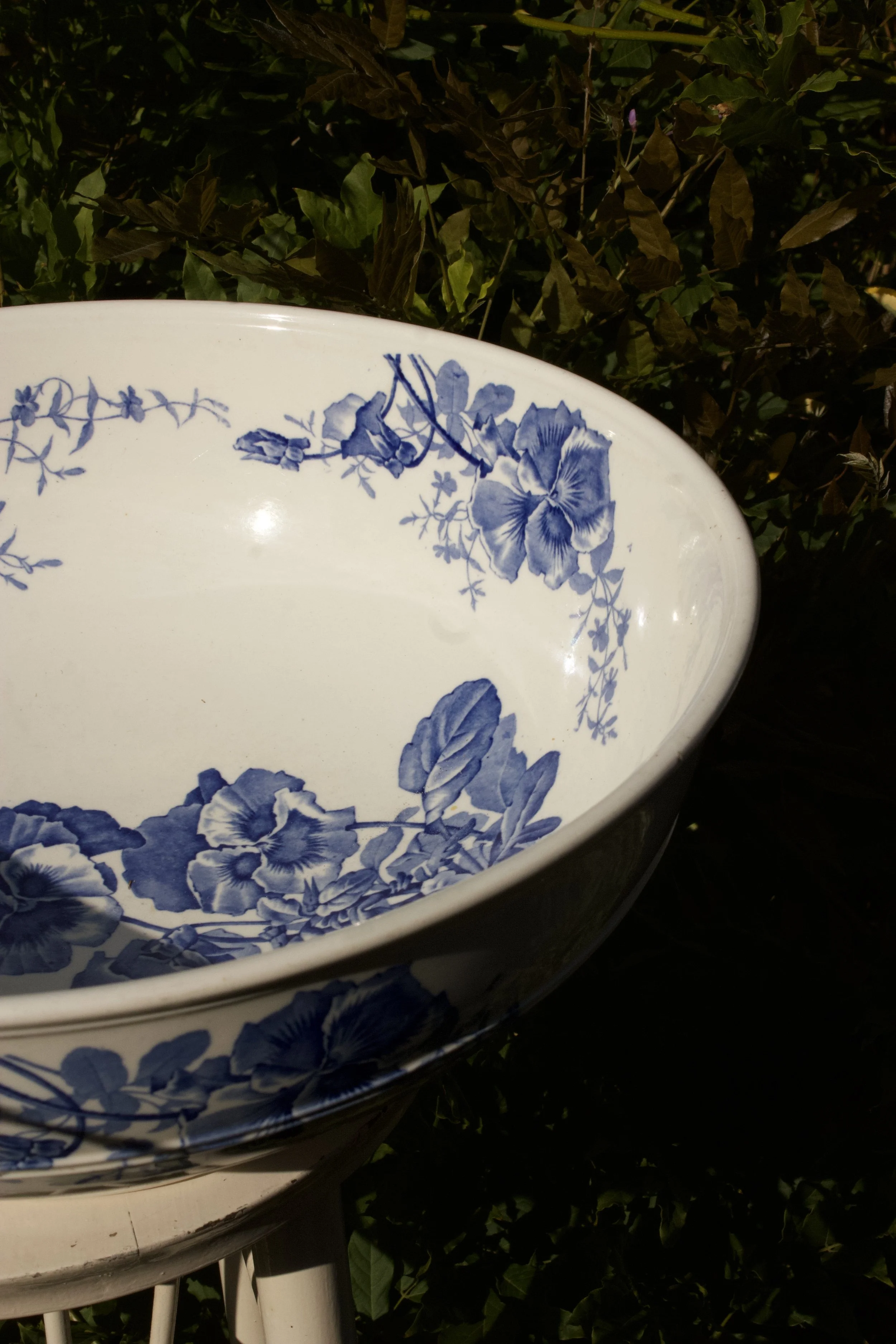 Antique blue and white ceramic wash bowl styled as vintage home décor inspiration.