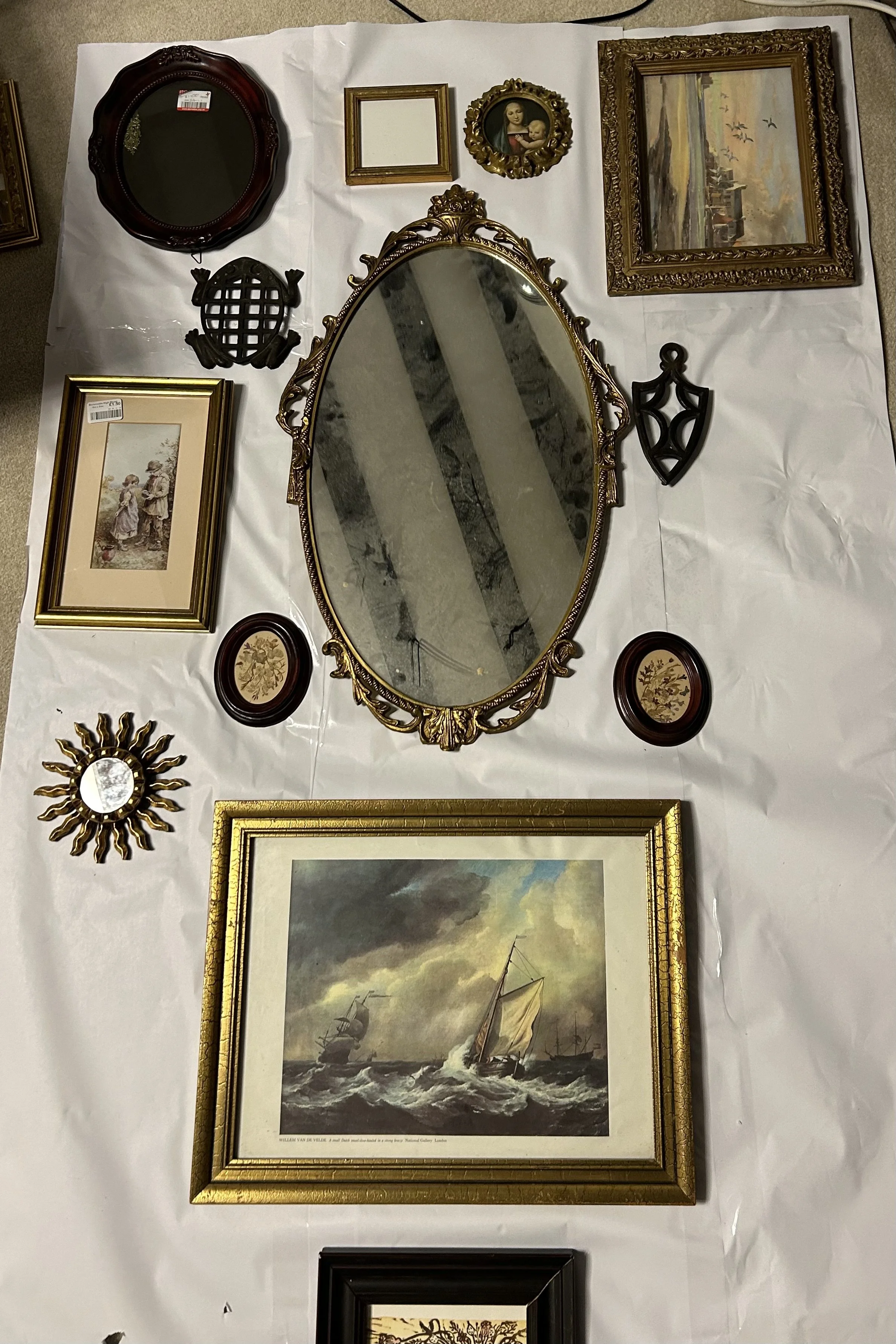Collection of antique mirrors, picture frames and vintage artwork arranged for styling inspiration.