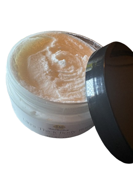 Open container of skin care body butter with black lid removed, showing the cream inside.
