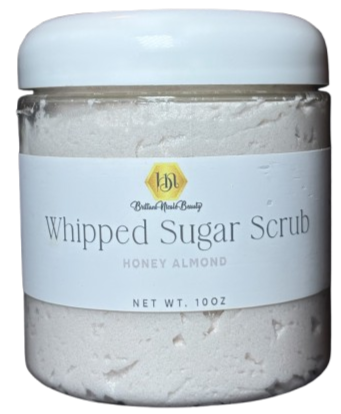 Container of whipped sugar scrub with honey almond scent.