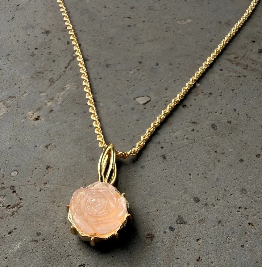 Goldene Halskette mit Anhänger  auf Granit