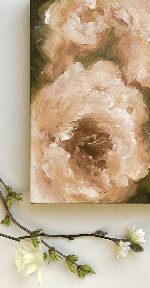 Abstract floral painting featuring soft, pastel-colored flowers on a canvas. A white flowering branch with budding leaves is placed below the painting.