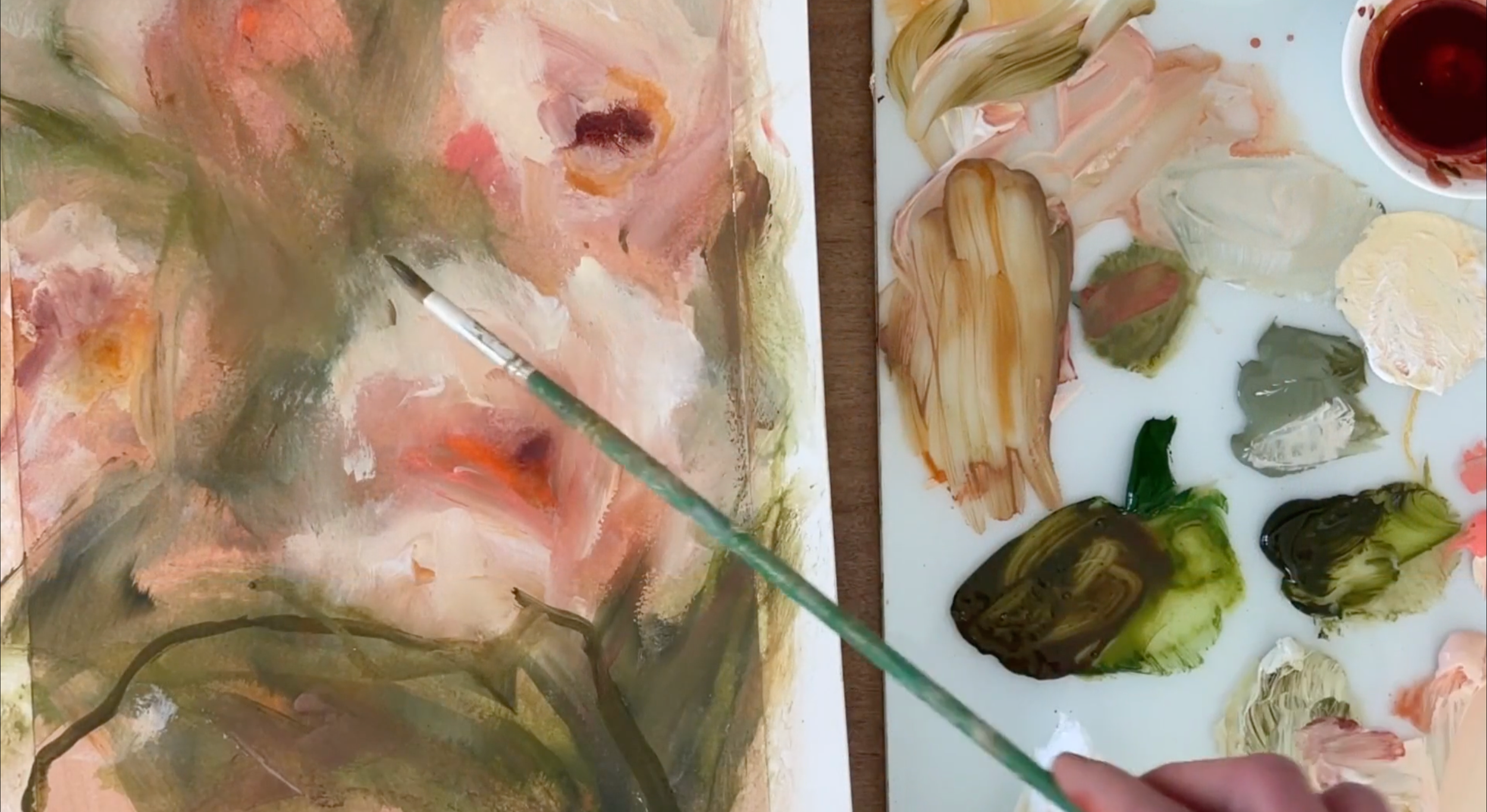 An artist painting an abstract landscape on a canvas, using a brush and vibrant colors, with a palette of mixed paints nearby.