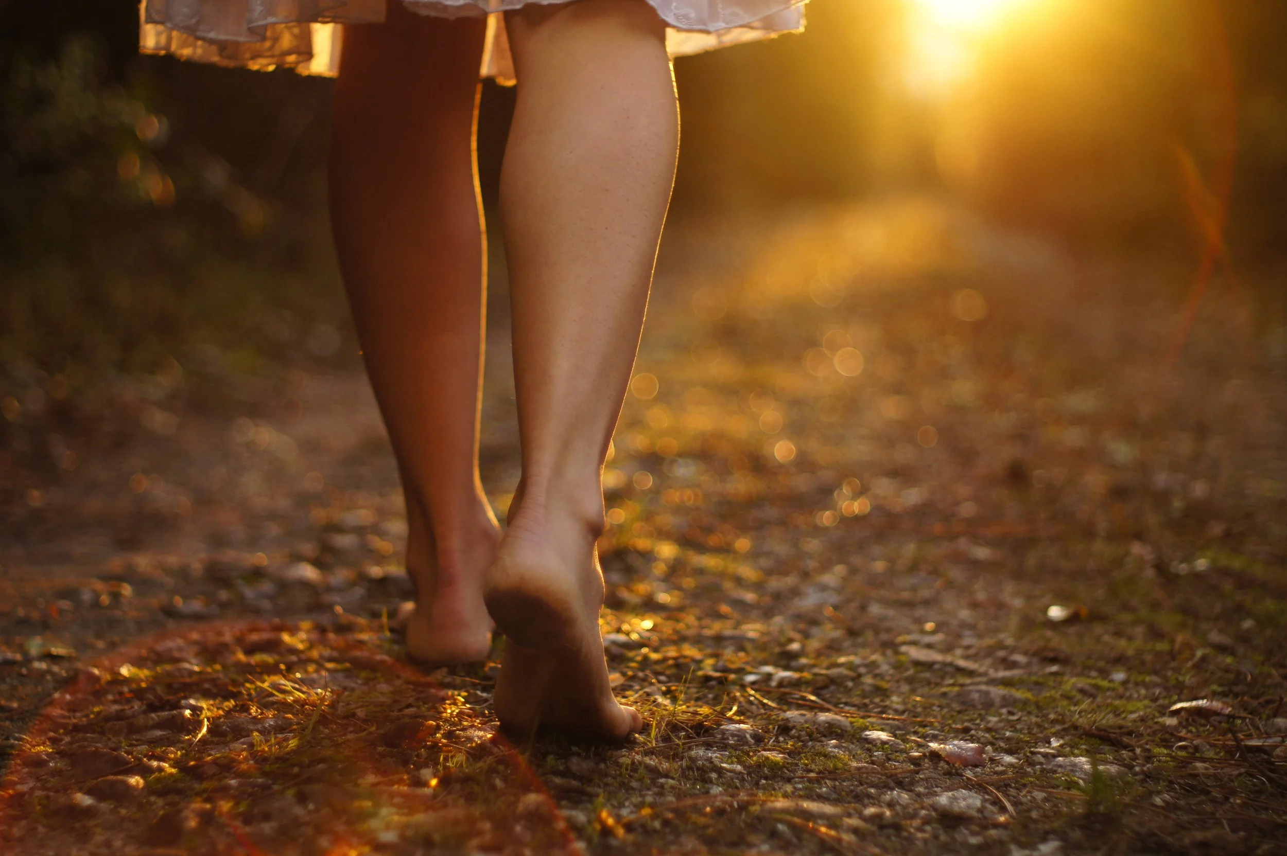 Walking forward, barefoot, into golden light