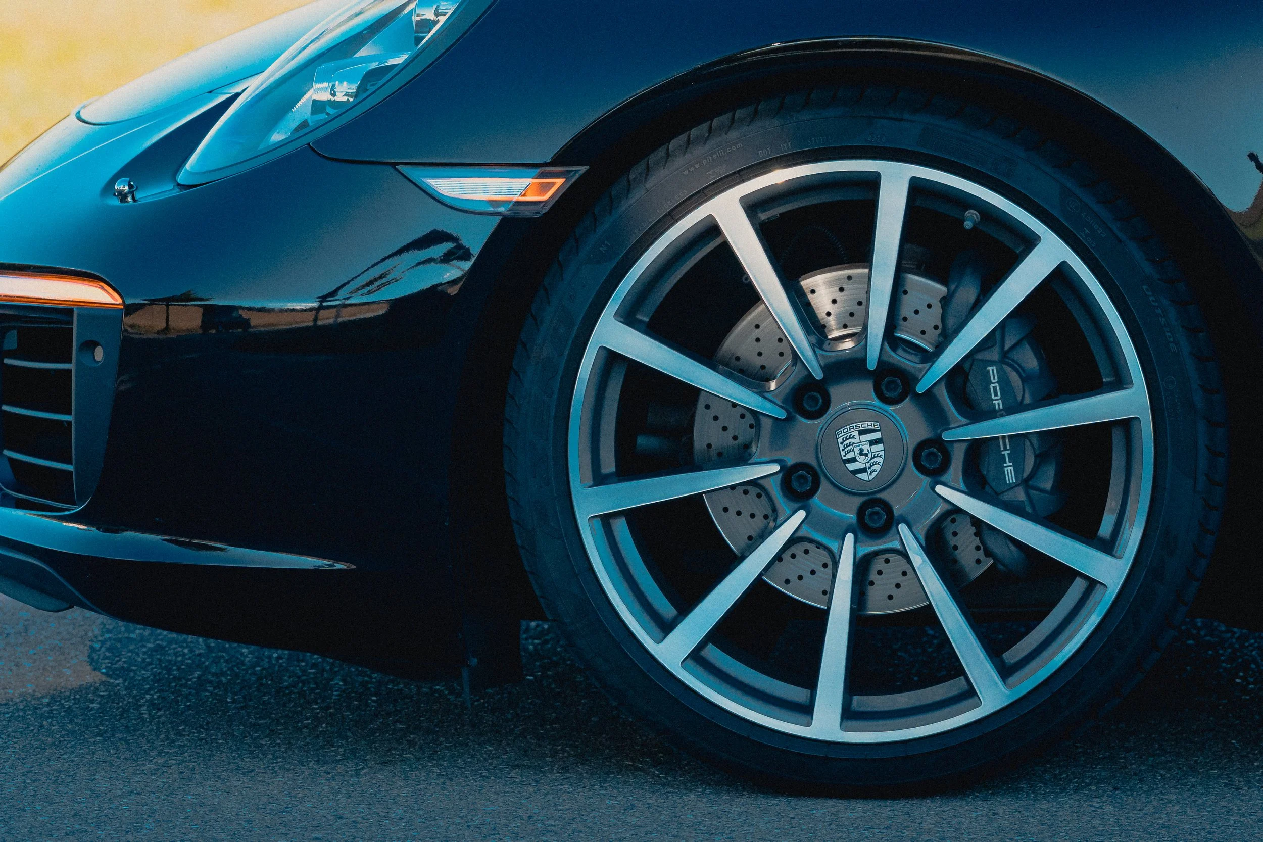 Detailaufnahme der Felge eines schwarzen Porsche 911