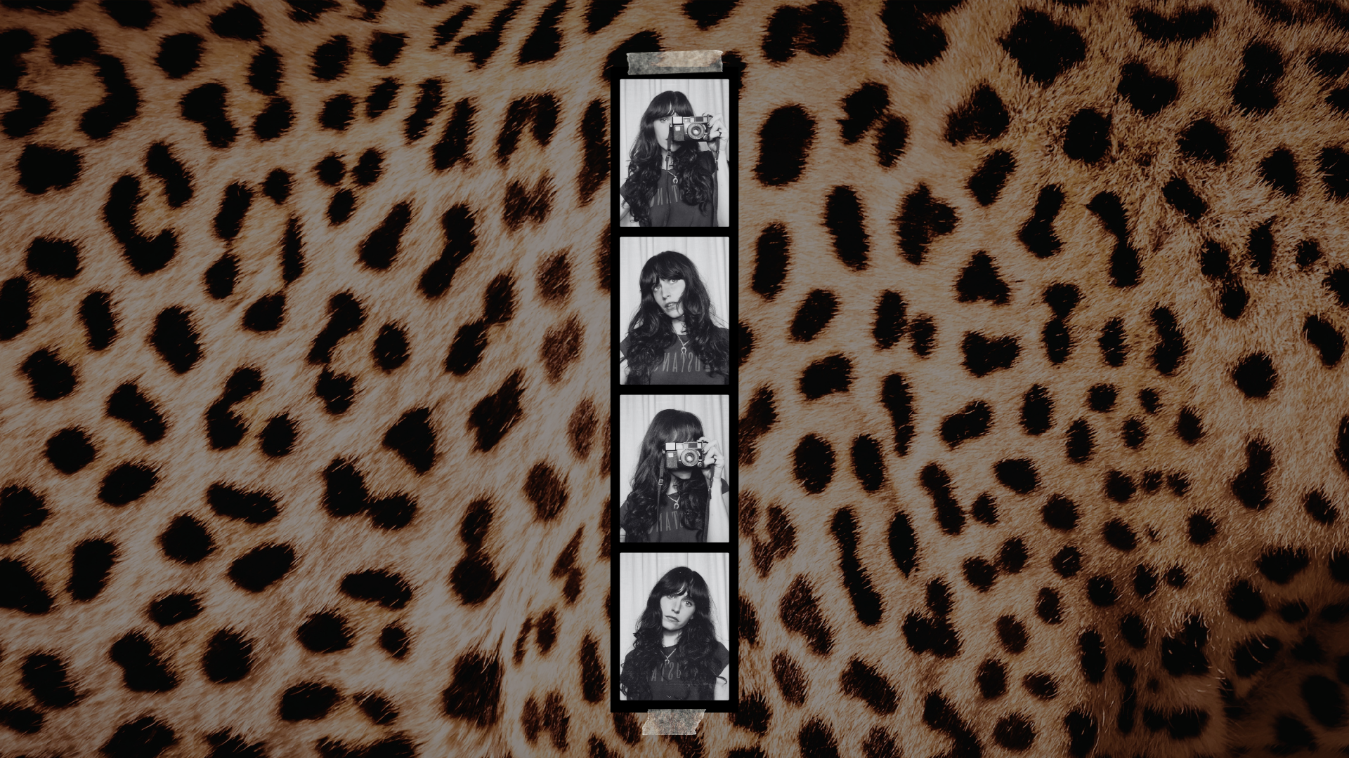 A strip of five black and white photos of a woman with long dark hair holding a camera, against a leopard print background.