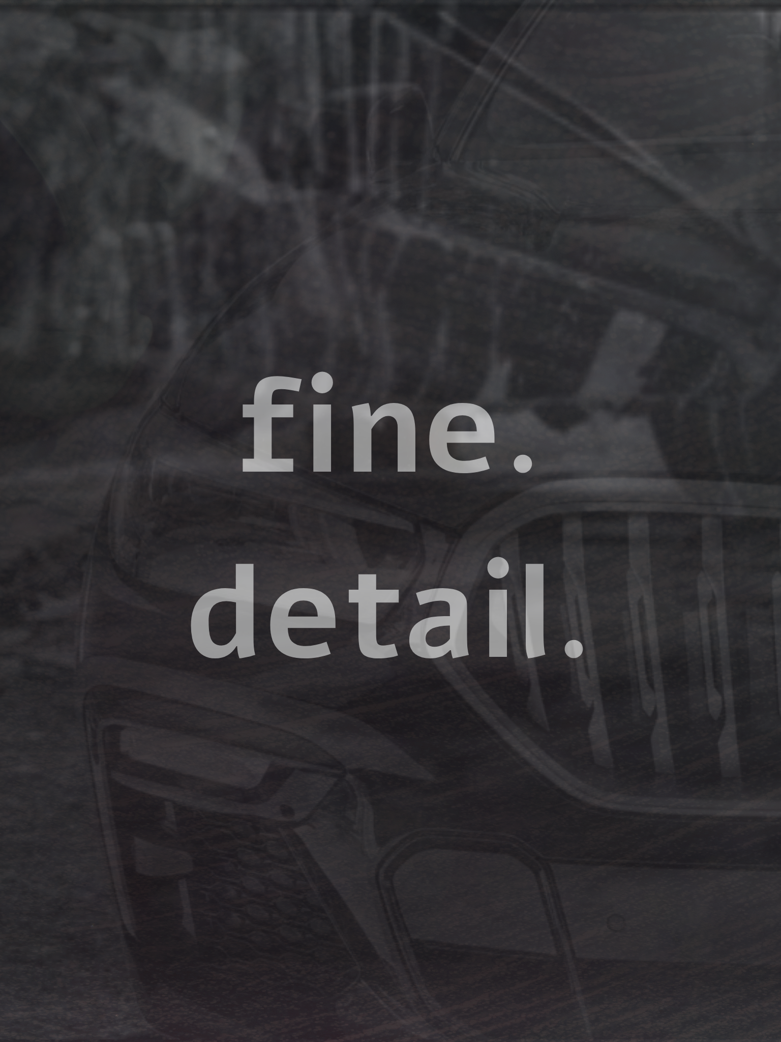 Close-up photo of a black surface with faint chalk-like markings and the words 'fine. detail.' written in light gray, semi-transparent text.
