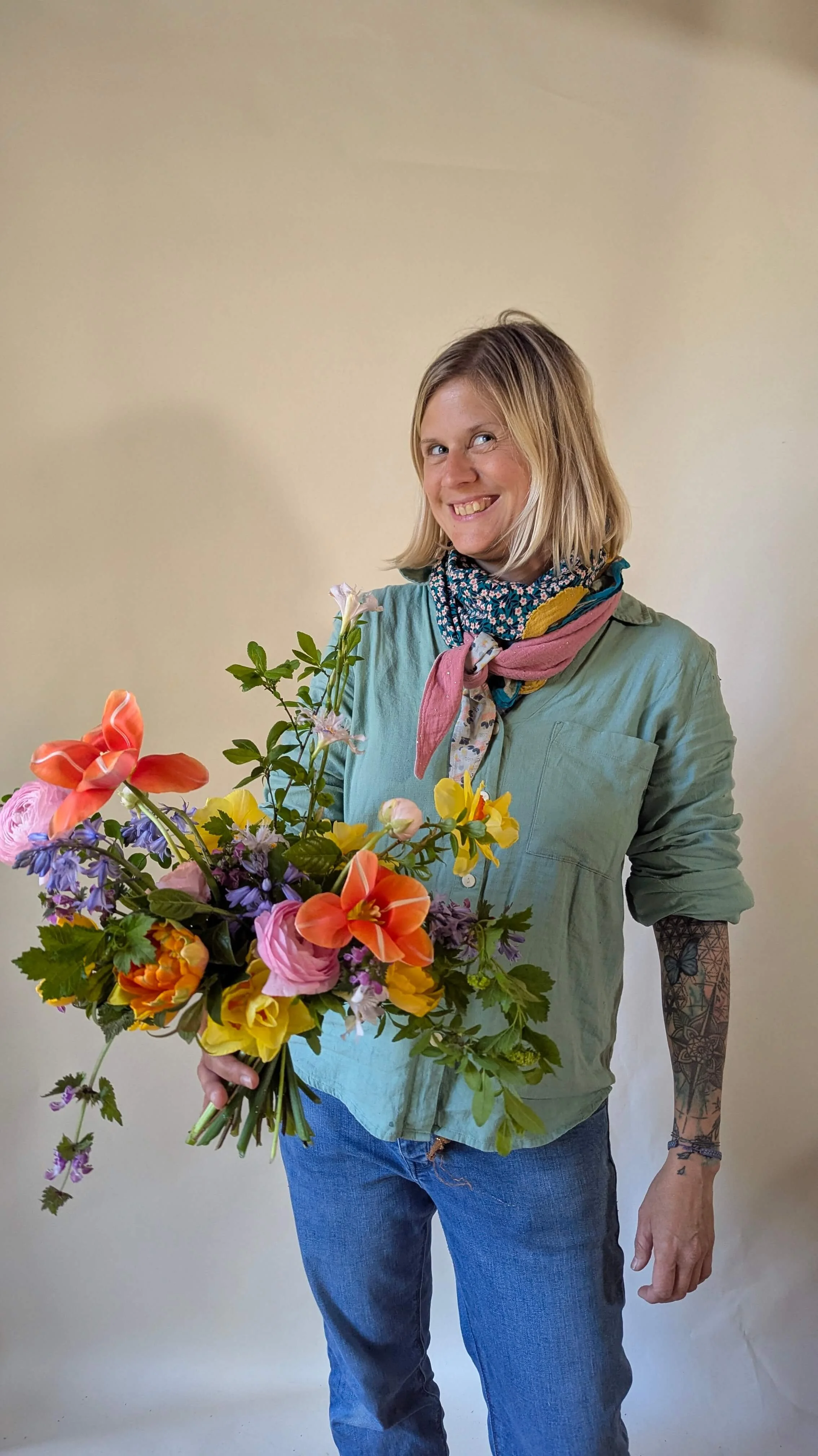 Participante avec un bouquet de fleurs du jardin pendant un stage d’art floral créatif.