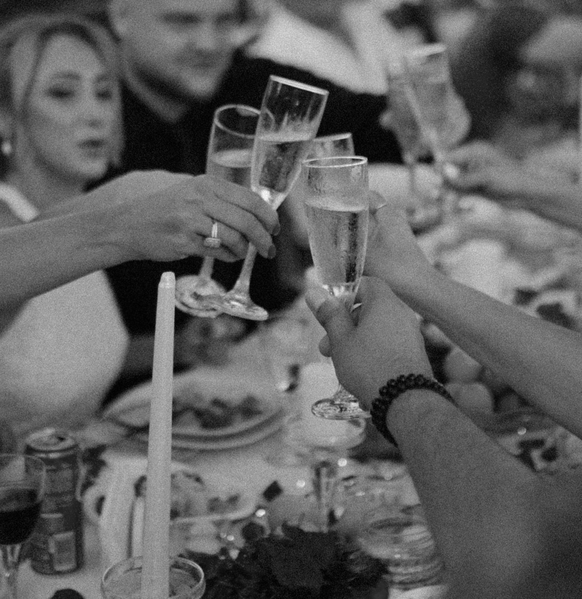 People raising glasses of champagne in toast at a celebration or event.