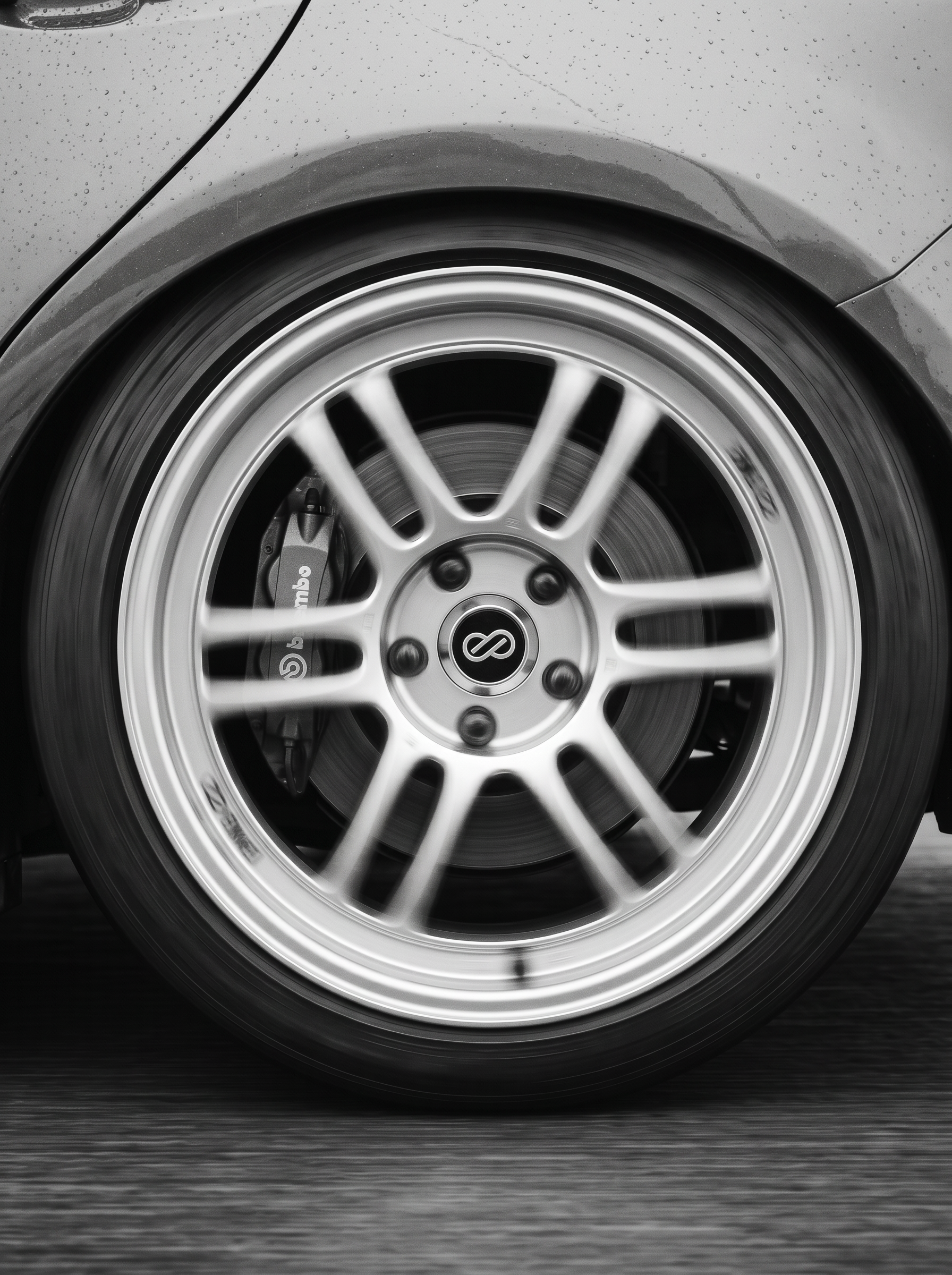 Close-up of a car wheel with an alloy rim and a Brembo brake caliper.