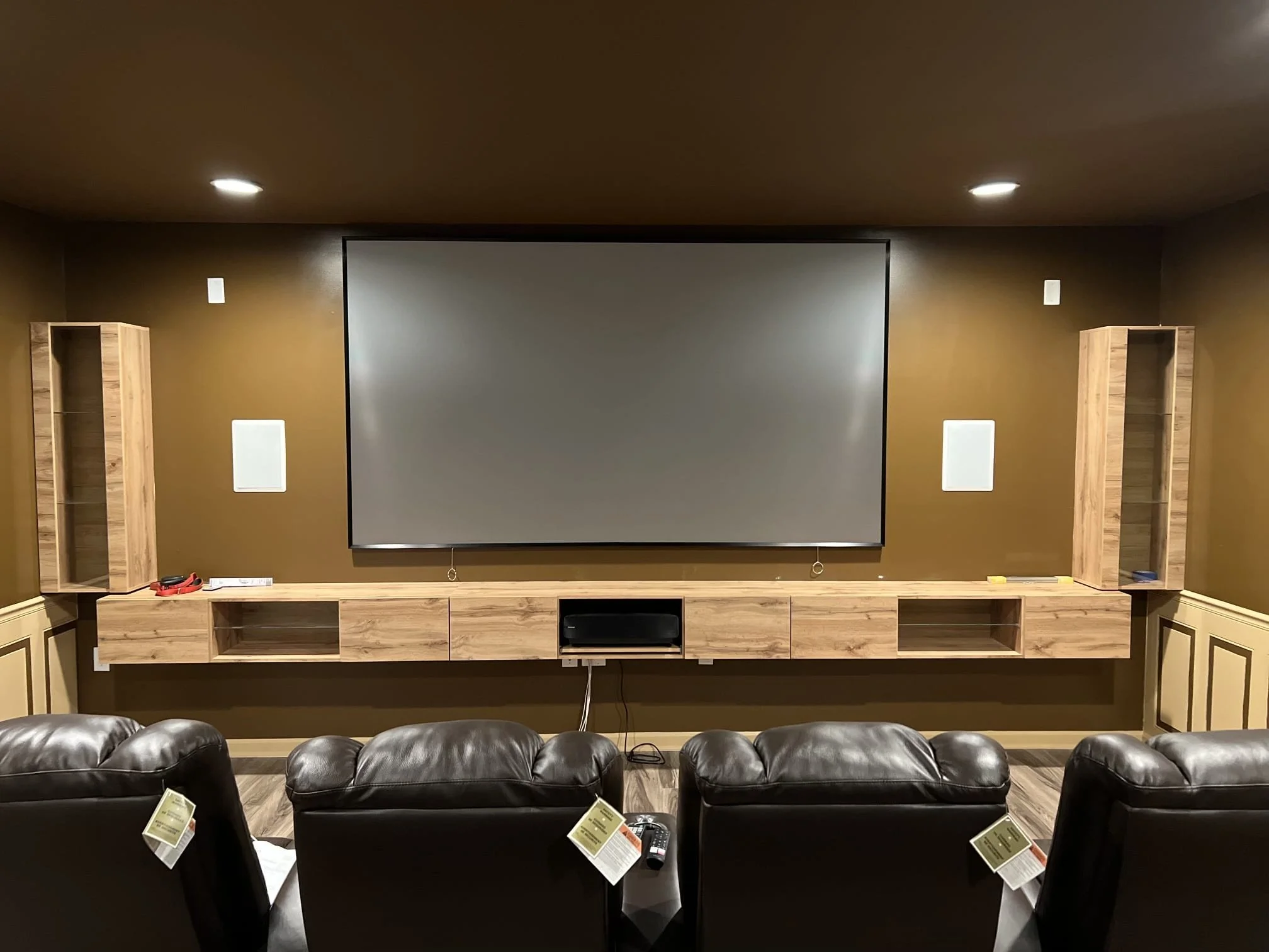 Custom home theater renovation with built-in cabinets and projection screen completed by Mr. H Remodel