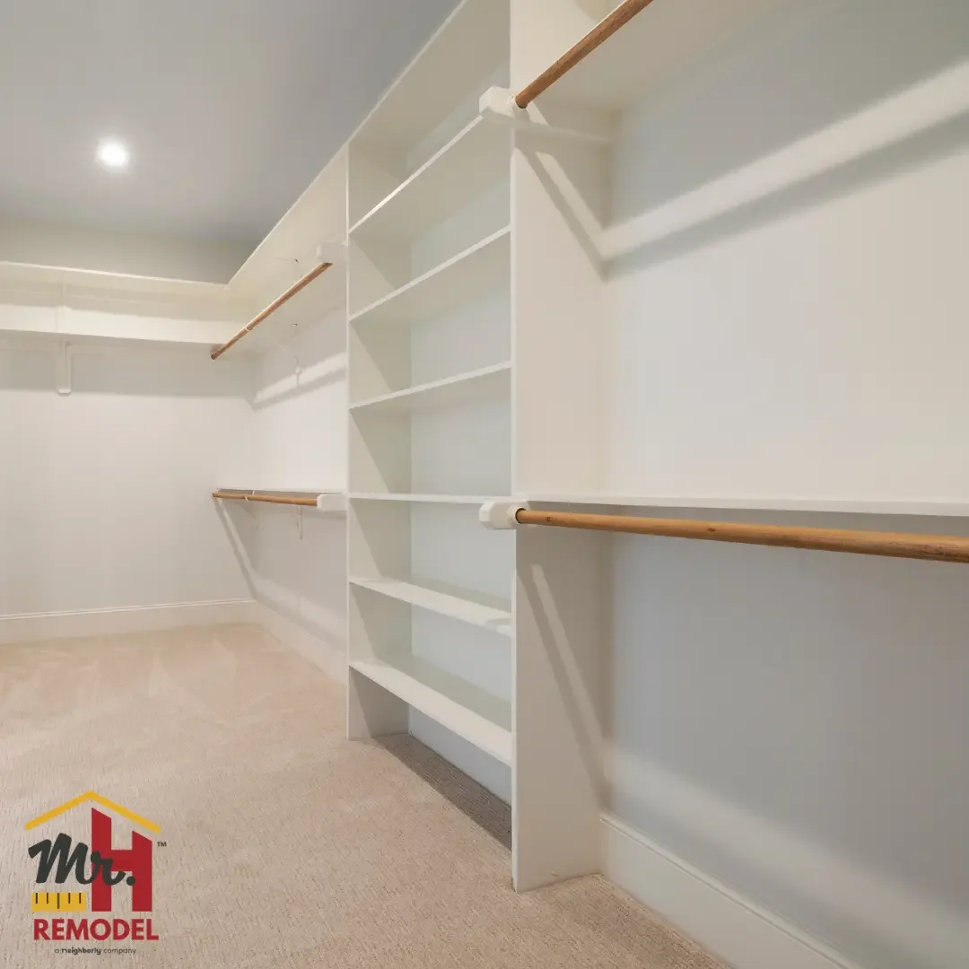 Custom walk-in closet with built-in shelving and hanging rods completed by Mr. H Remodel
