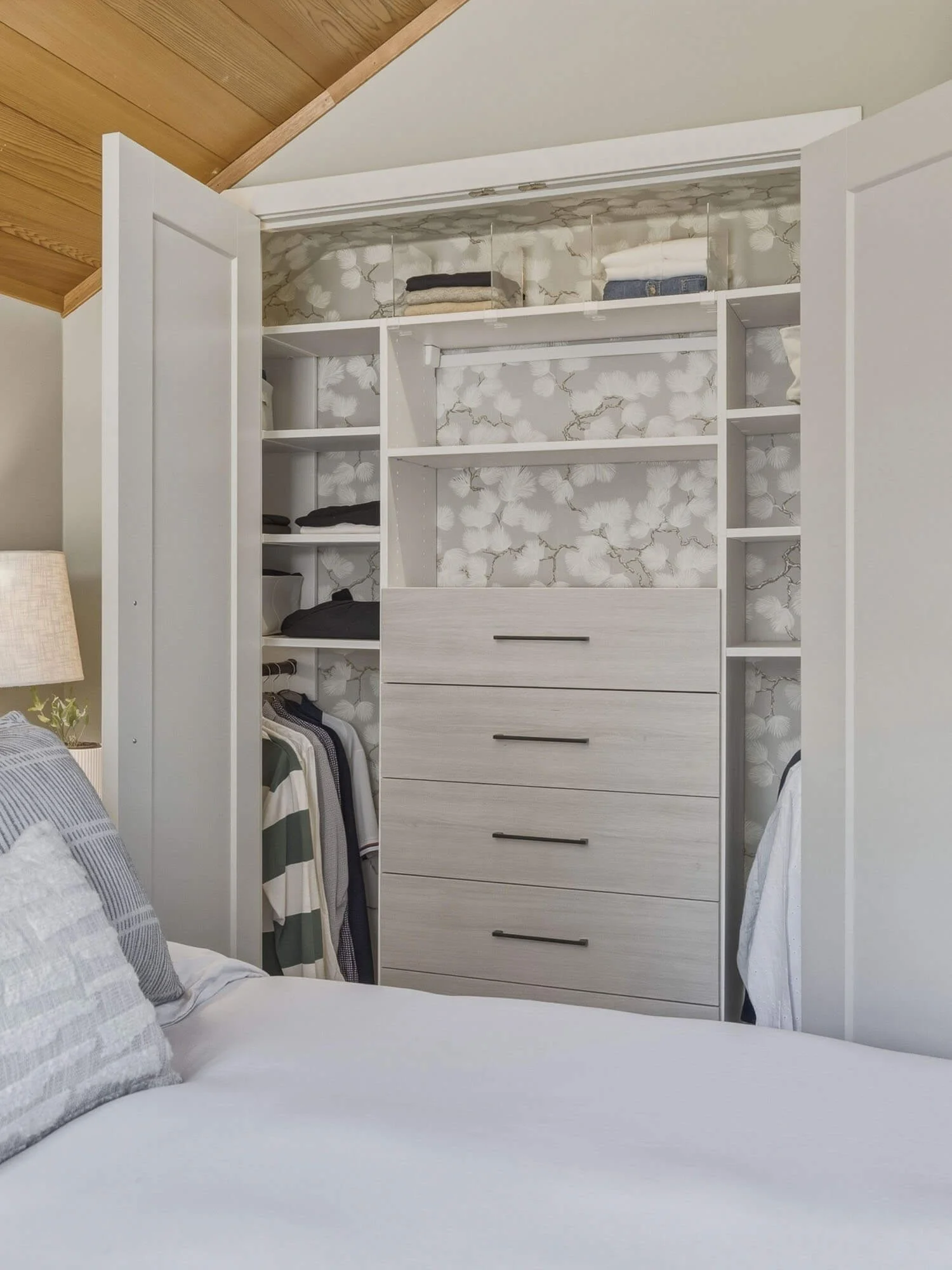 Detailed look at the custom-organized primary bedroom California Closets system within the private upper-level master suite at 6117 Eagle Drive, maximize storage utility.