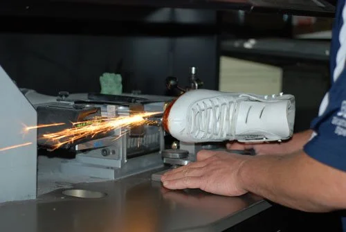Sharpening blade on a white figure skate