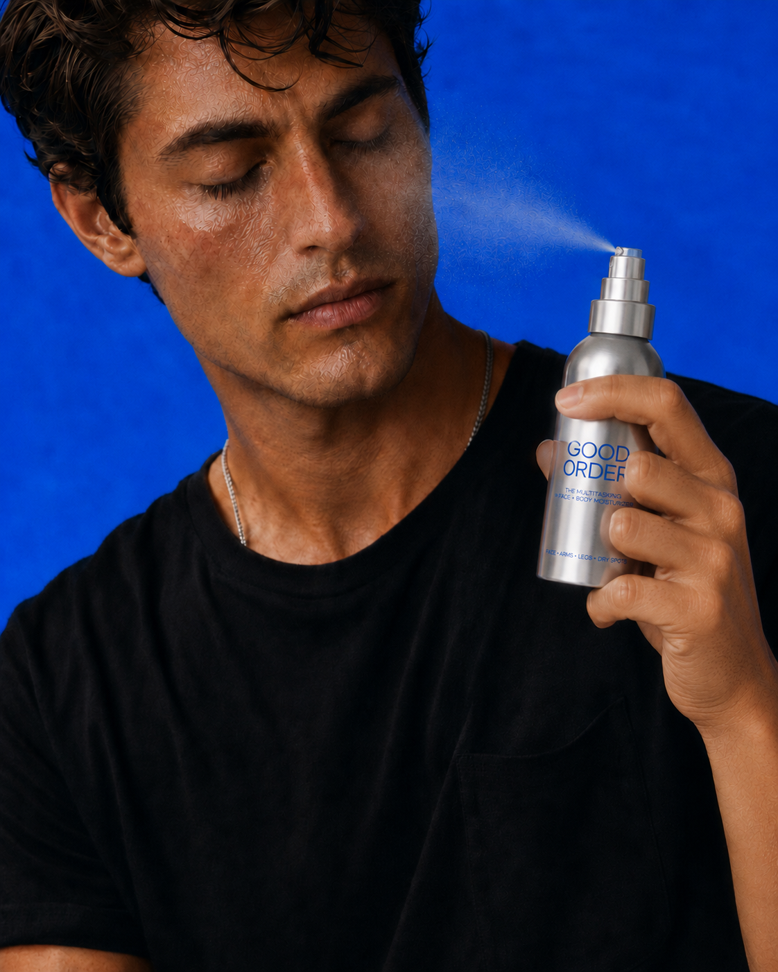 Man applying Good Order Moisture Spray directly to his face