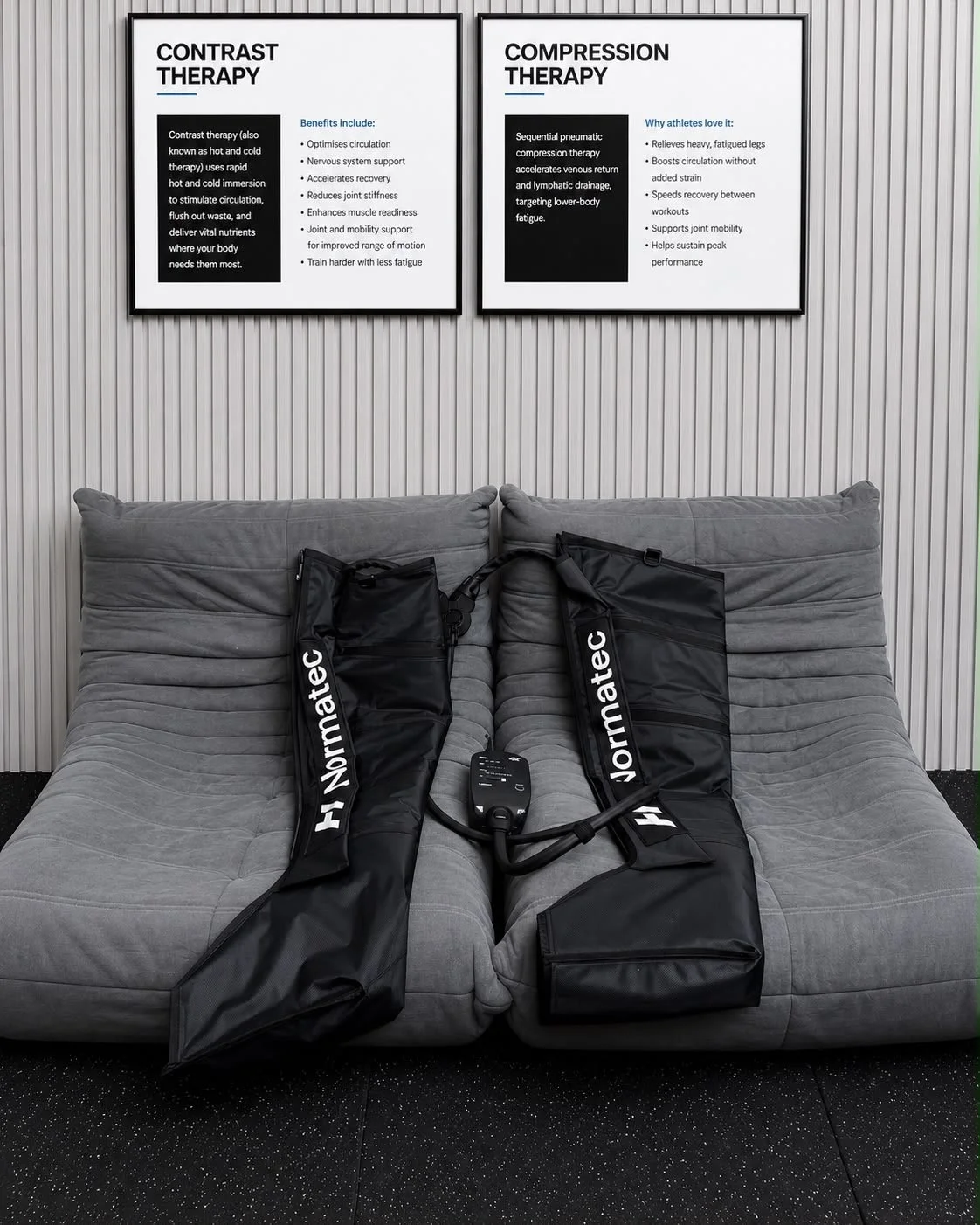Two rehabilitation bags with medical control unit resting on a gray couch in a clinic, with signboards on the wall explaining contrast and compression therapy.