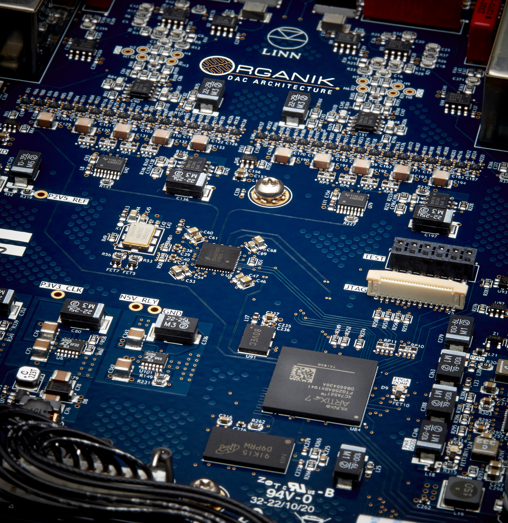 Placca madre di computer con vari componenti elettronici, circuiti e connettori, marchiata con il logo 'ORGANIK' e scritto 'DAC ARCHITECTURE'.