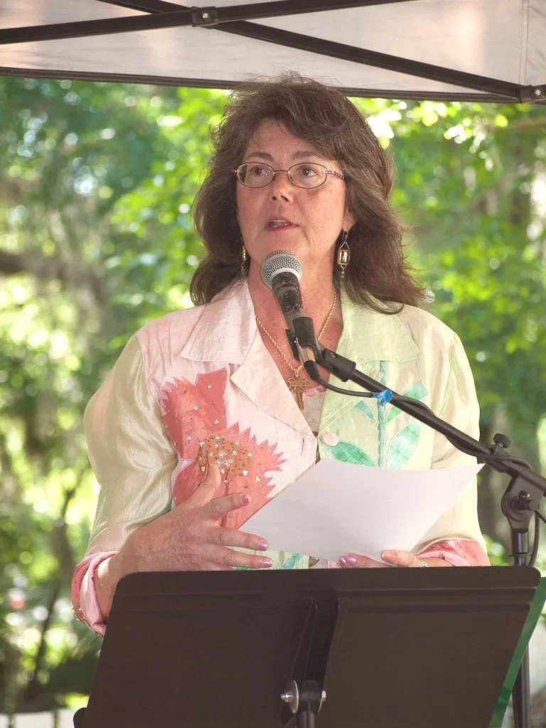 Karen M. Peluso reading poetry in Charles Street Gallery garden. Photo by Richard Darby. 2011