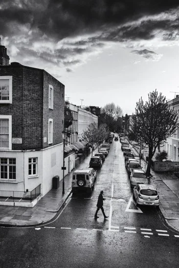 Infrared- "Crossing Lonsdale, London U.K." Street. Building. Man. Cars. Dark. Sky. Clouds. Lines.