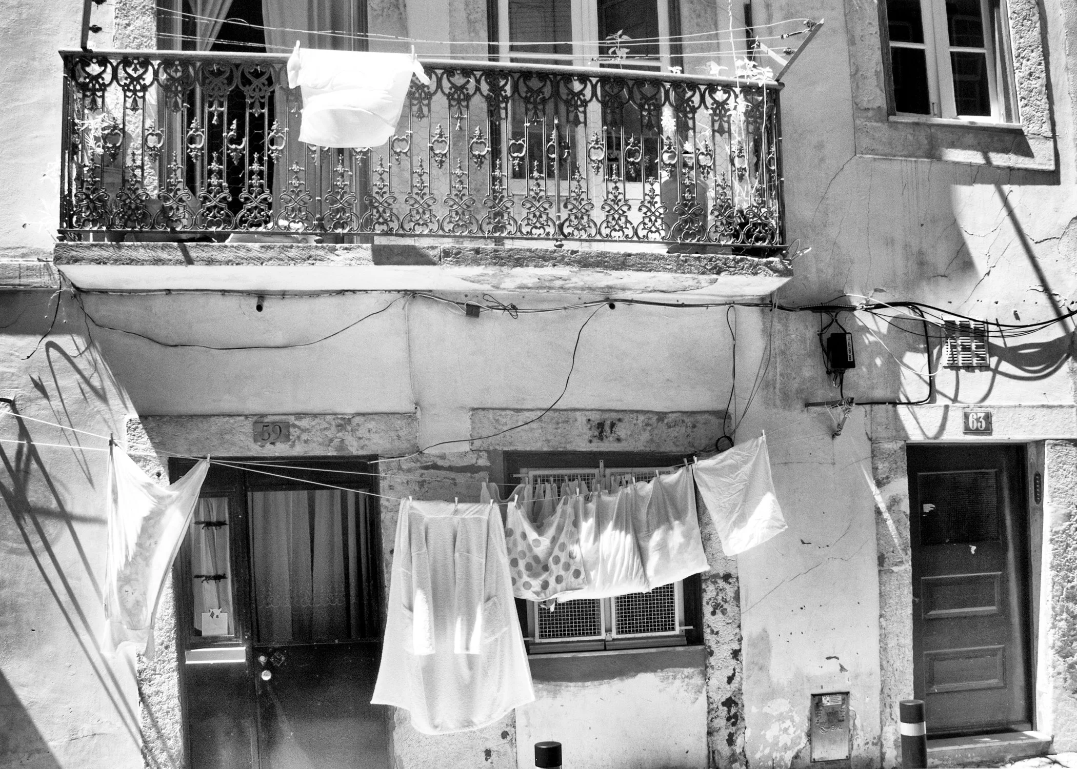 Classic B&W: "Laundry Day, Portugal" Linens. Wrought Iron. Railing. Door. Windows.