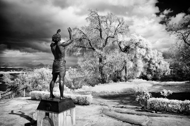 Infrared- "Conversation With God: Saint John the Baptist" Statue. Man. Trees. Garden. Clouds. Mission San Juan Bautista, CA