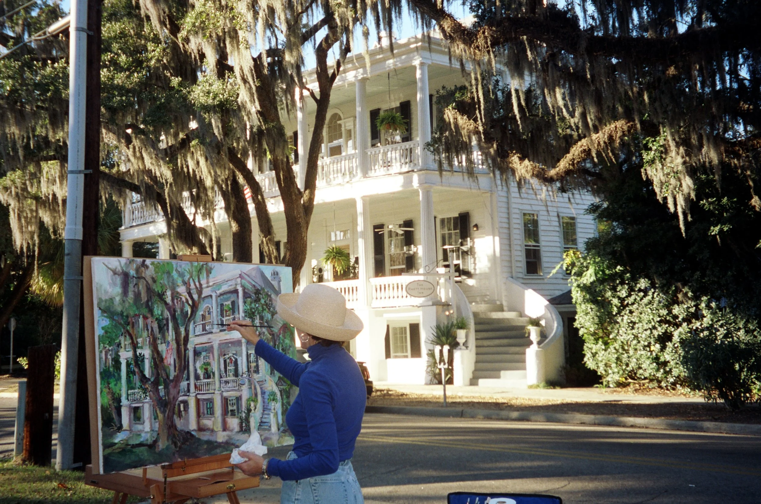 Simply Color: "Artist Painting the Rhett House Inn" Woman. Hat. Easel. Antebellum. Building. Staircase. Rounded. Trees. Street. Beaufort, SC