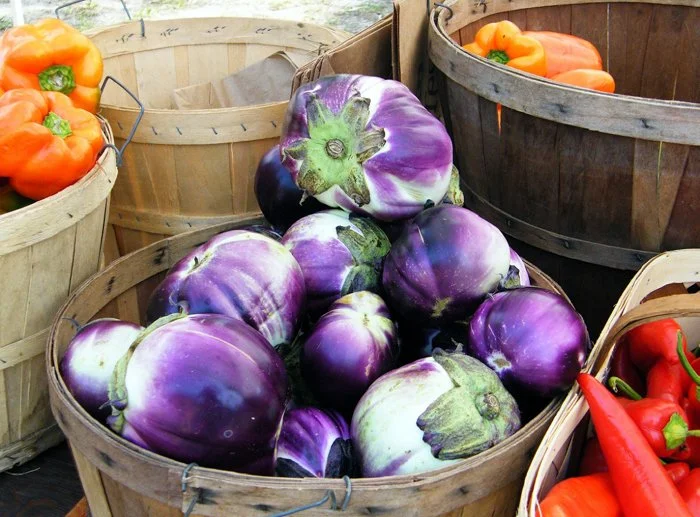 Simply Color-"8-Ball Eggplants at the Farmers Market" Port Royal SC (Published in Beaufort County 2009 Annual Calendar in Support of Rural and Critical Lands). Baskets. Peppers. Purple. Orange. Red. 
