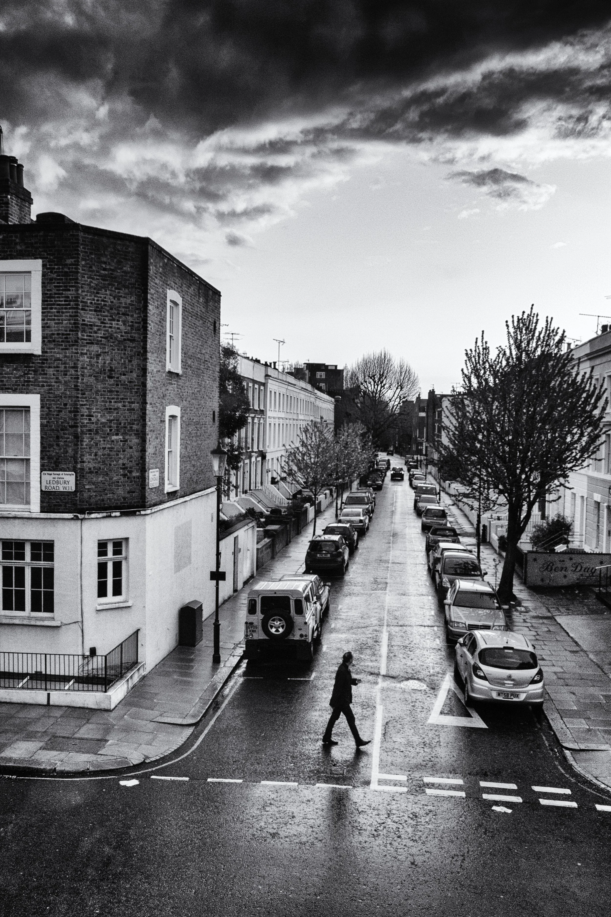 Infrared- "Crossing Lonsdale, London U.K." Man. Street. Crosswalk. Building. Clouds.