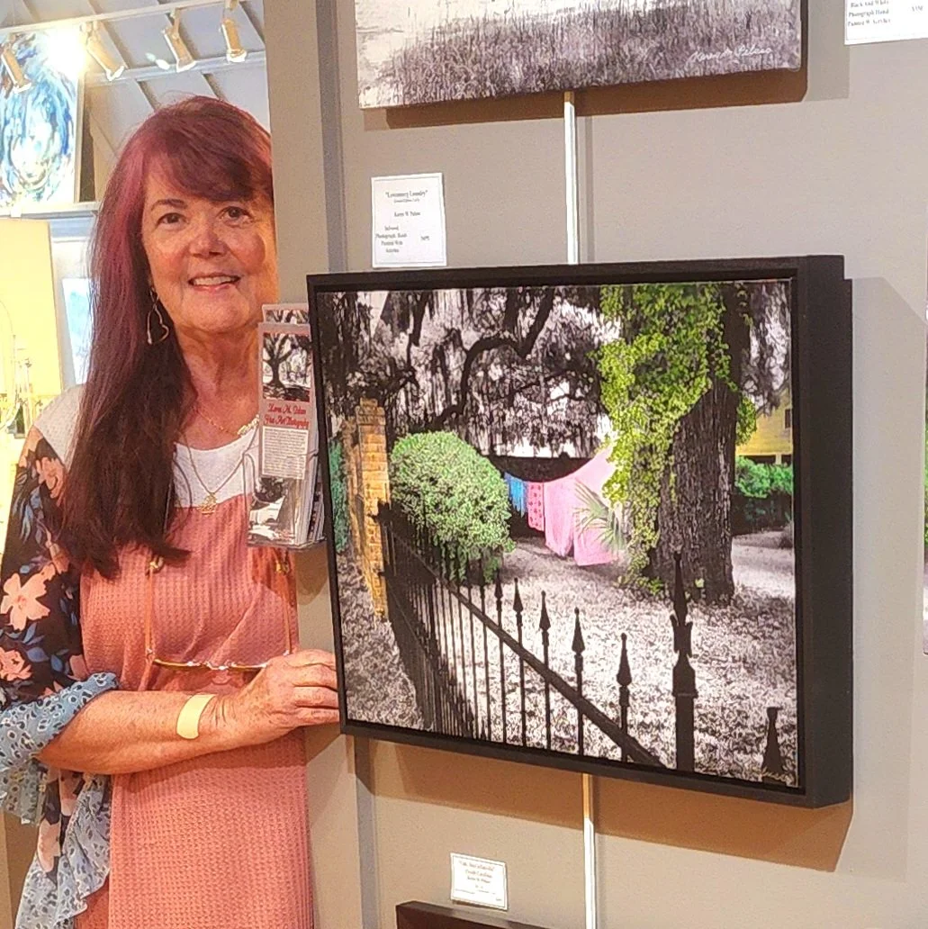 Karen M. Peluso with her art at the Brick Wall Gallery  of Beaufort Art Association.  2025