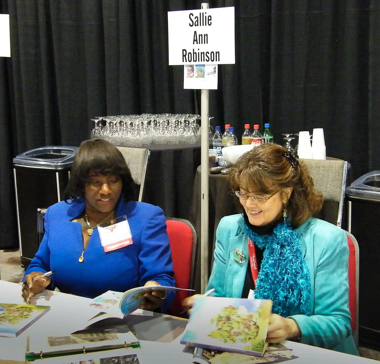 Cookbook author Sallie Ann Robinson and Karen M. Peluso signing Sallie's book with  Karen's black & white photo illustrations. "Cooking the Gullah Way: Morning, Noon & Night" UNC Press. SC Book Festival, Columbia, SC. 2008
https://www.sallieannrobins