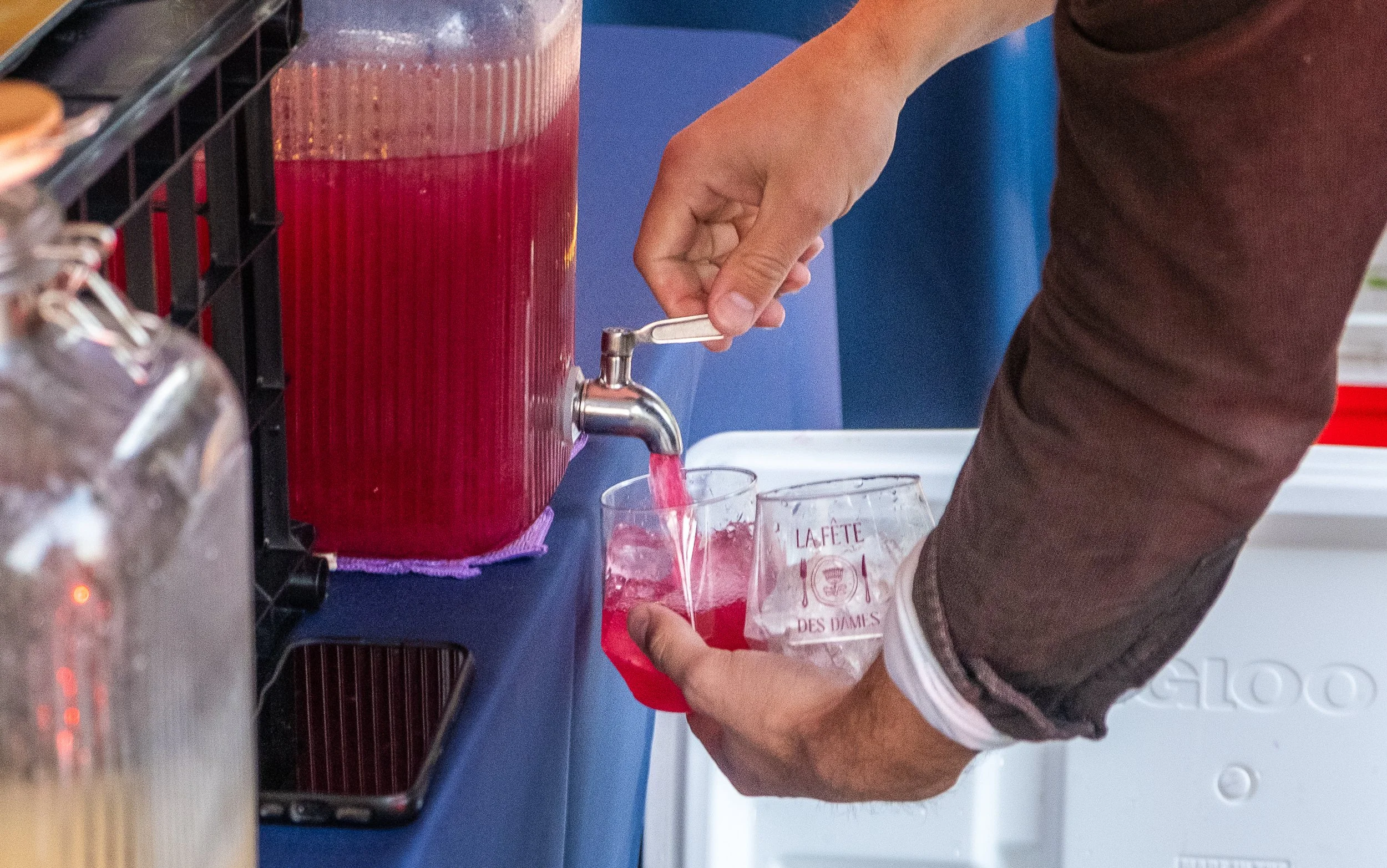  A person pouring a cocktail from a dispenser into a cup at “La Fete De Dames” a fundraiser event organized by Les Dames Nashville 
