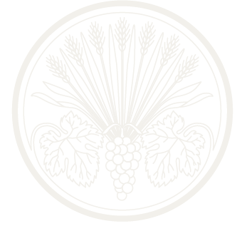 A circular logo with stalks of wheat and grapes to symbolize the organization Les Dames d'escoffier international. It sits behind the text on the page.