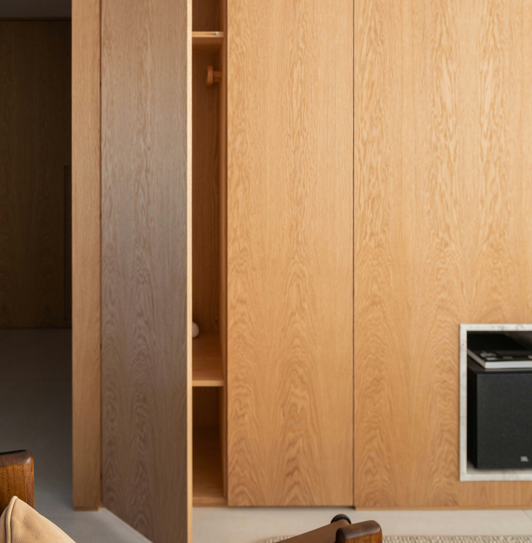 Custom wood wall panels and built-in storage in a warm modern interior.