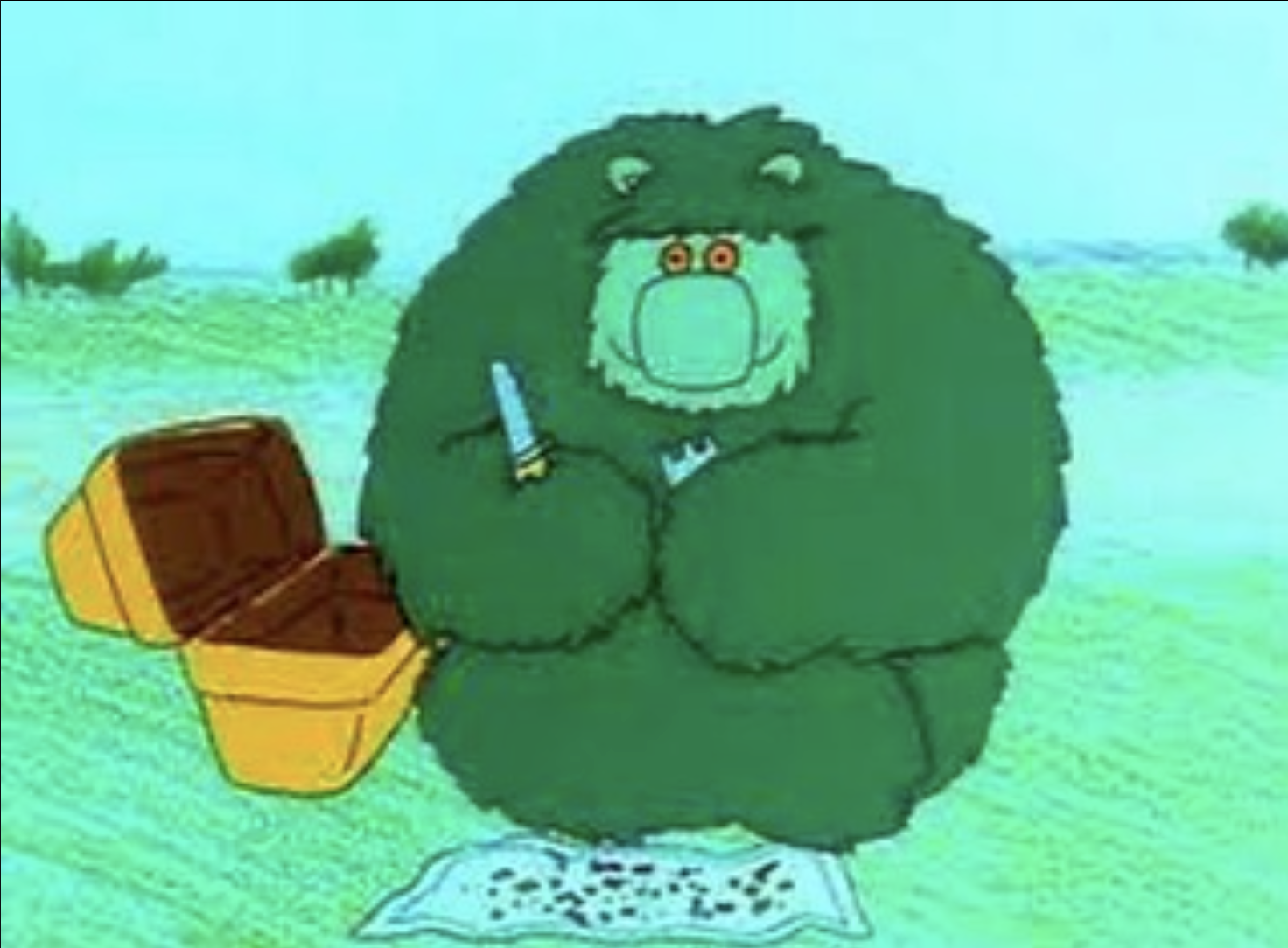 Animated green bear with glasses, holding a knife, sitting on an open book, outdoors with green grass and trees in the background.