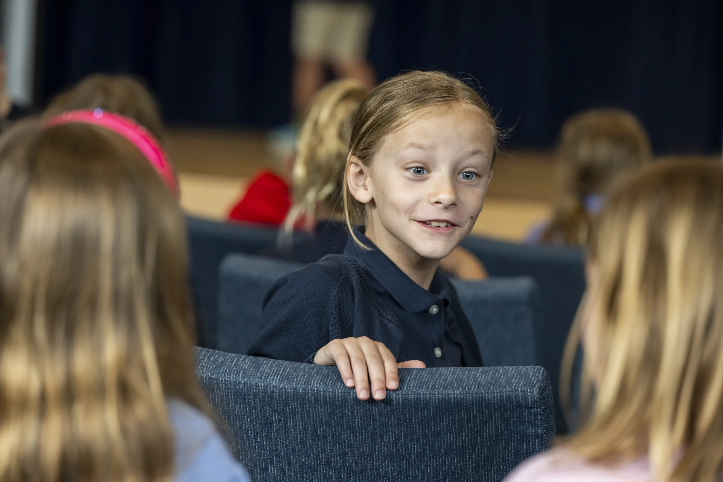 Community Meeting opens the day with sharing, celebration, and early public speaking.