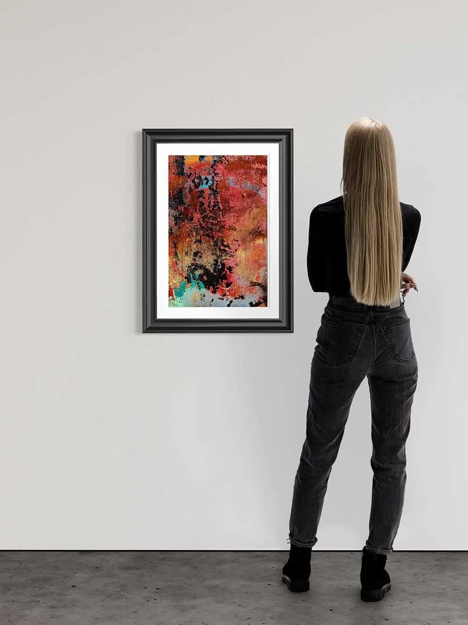 A woman with long blonde hair stands in front of an abstract painting at an art gallery.