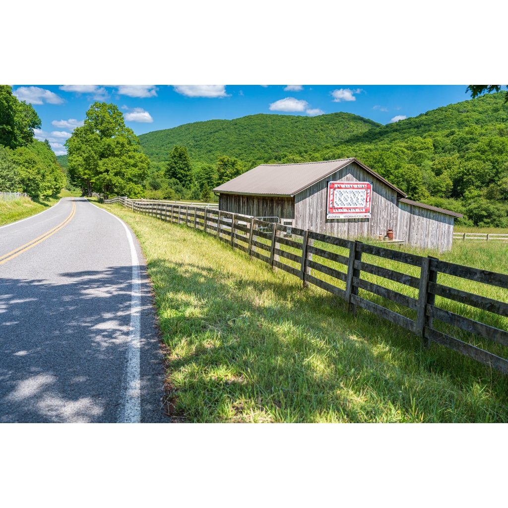 The Love Barn in Burke's Garden, Virginia, photographed along a quiet country road with the Appalachian Mountains in the background. Fine art landscape photograph by Two Dogs and A Camera.